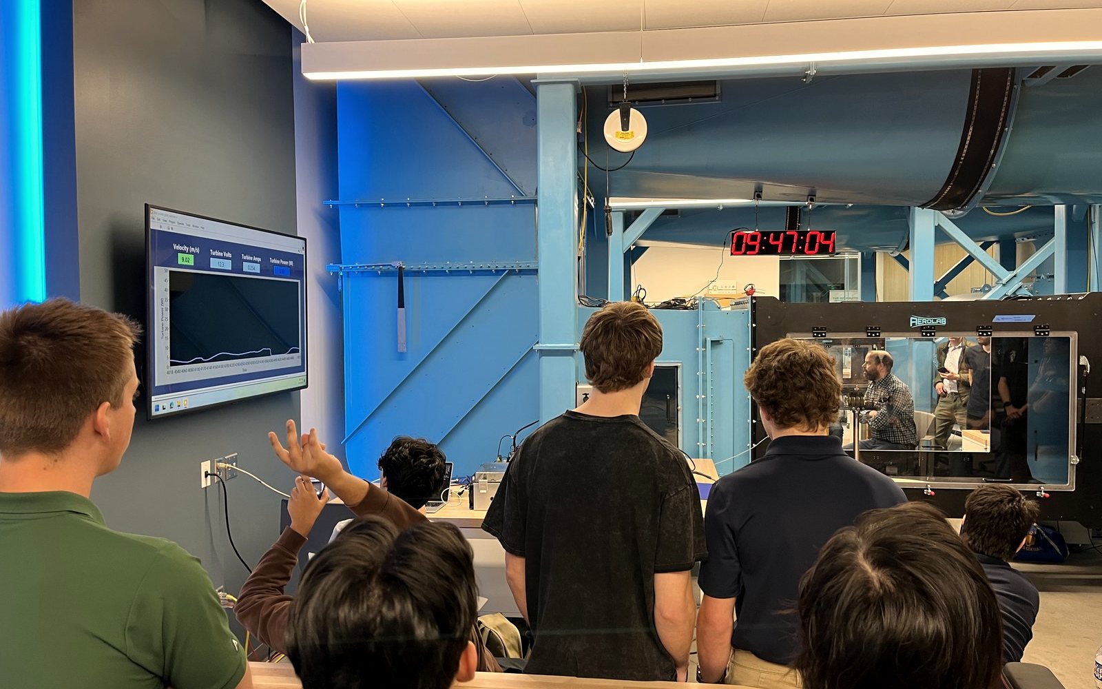 The team watching the turbine inside the wind tunnel test section